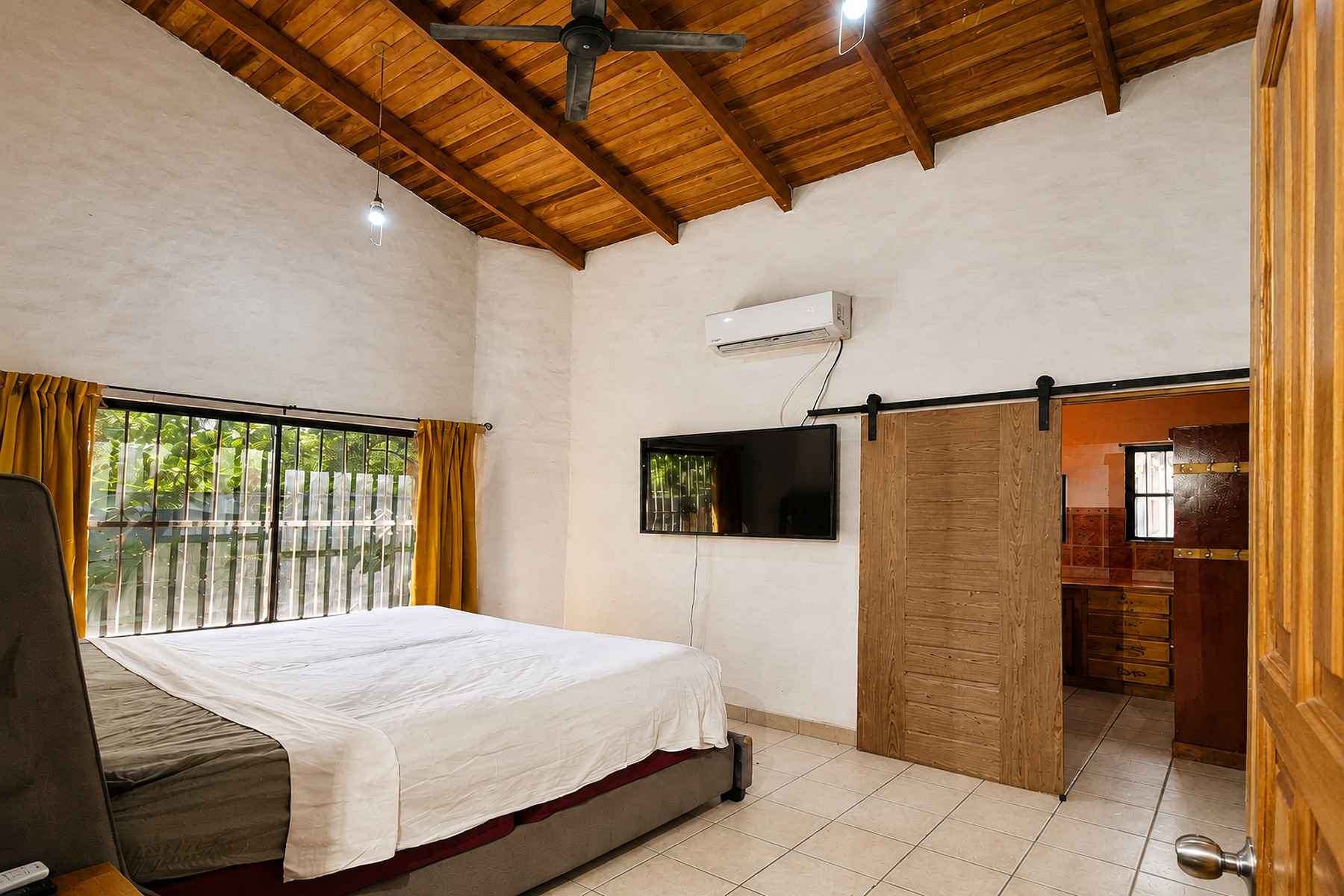 Bedroom with a wood ceiling and barn door
