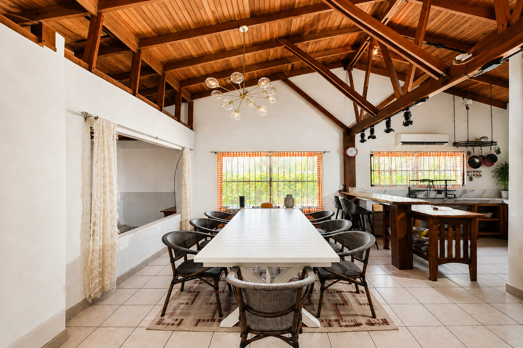 Dining area and kitchen with wood beams