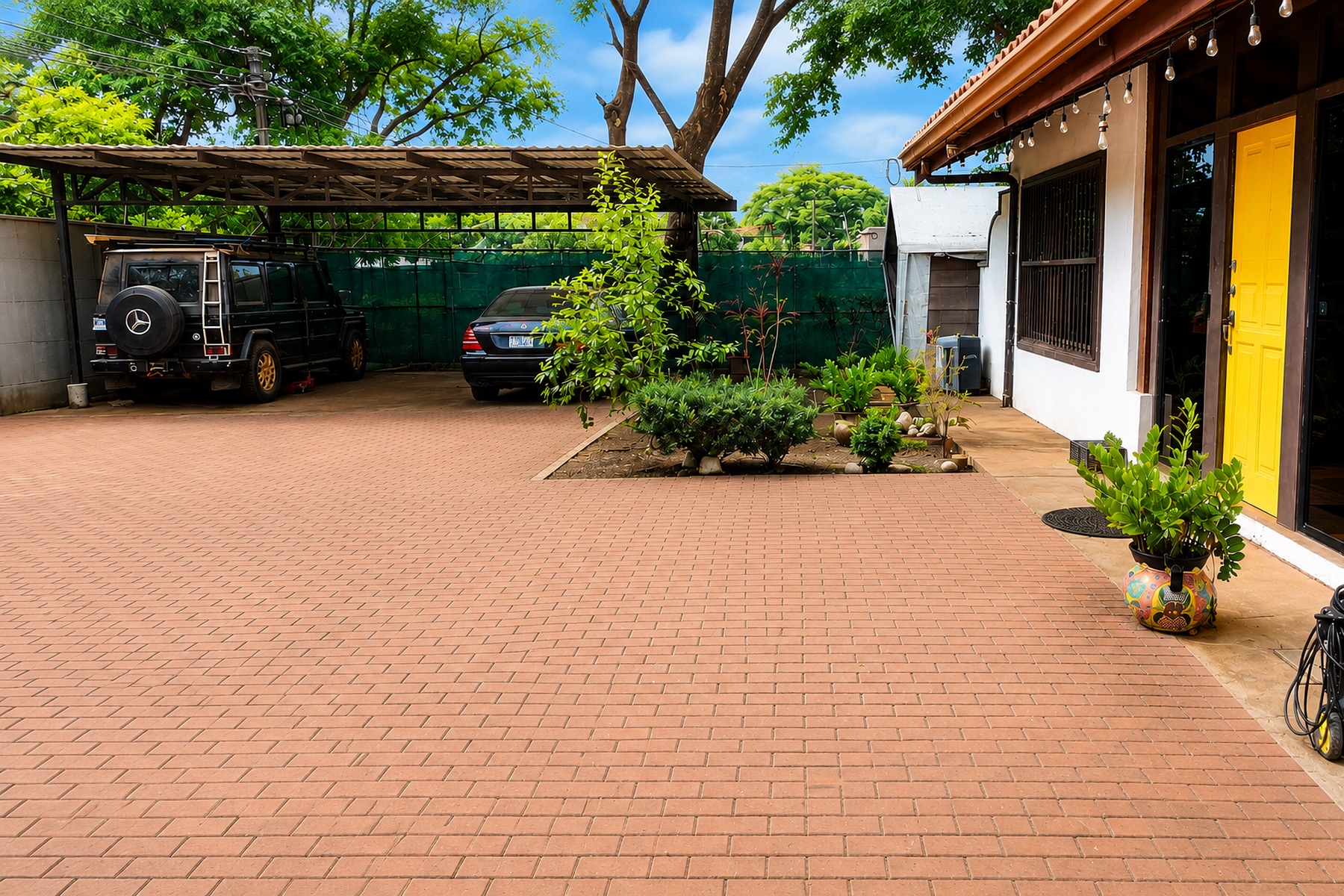 Paved driveway and covered parking for three cars