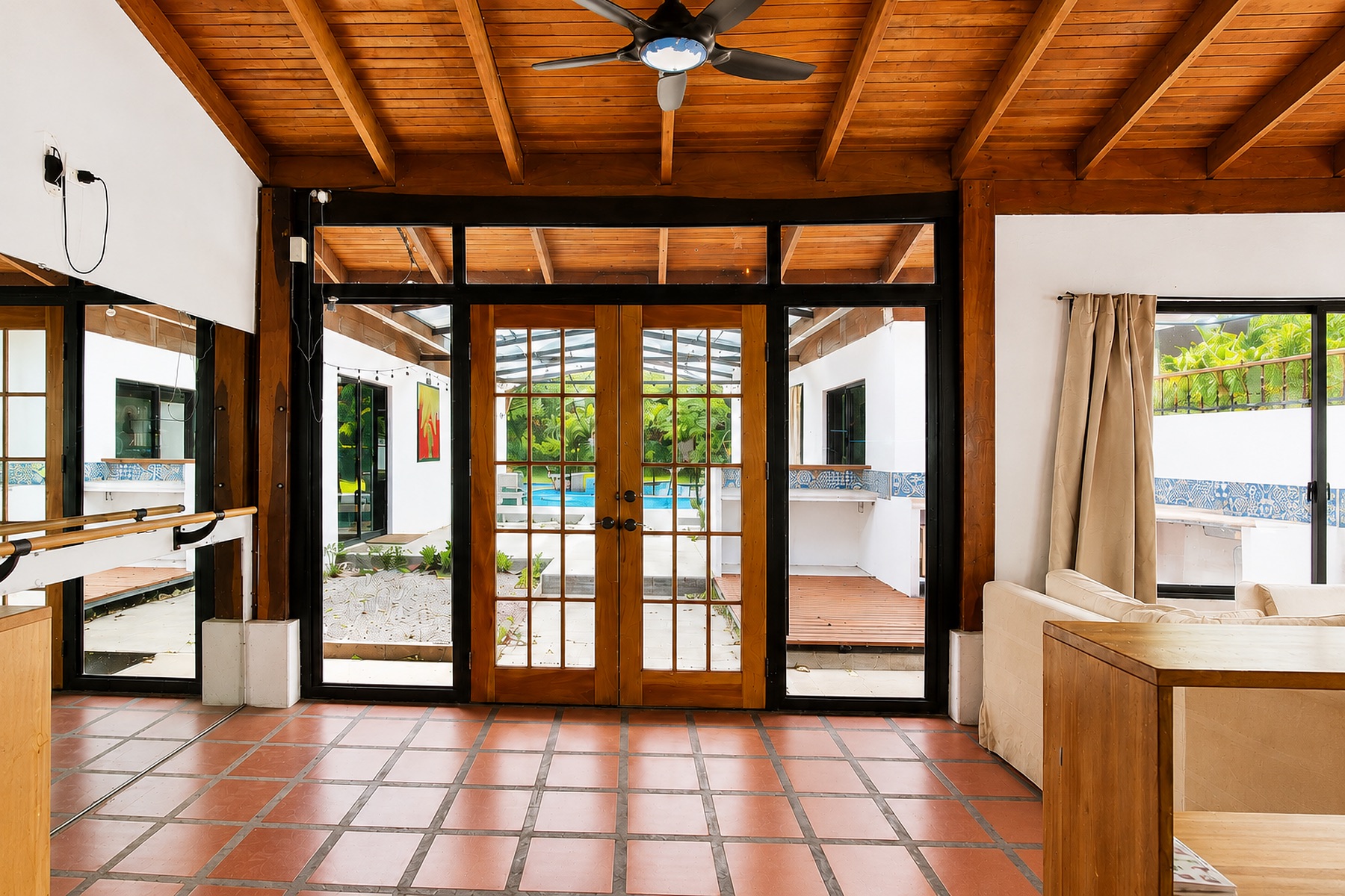 Sunroom with glass doors looking out to the pool