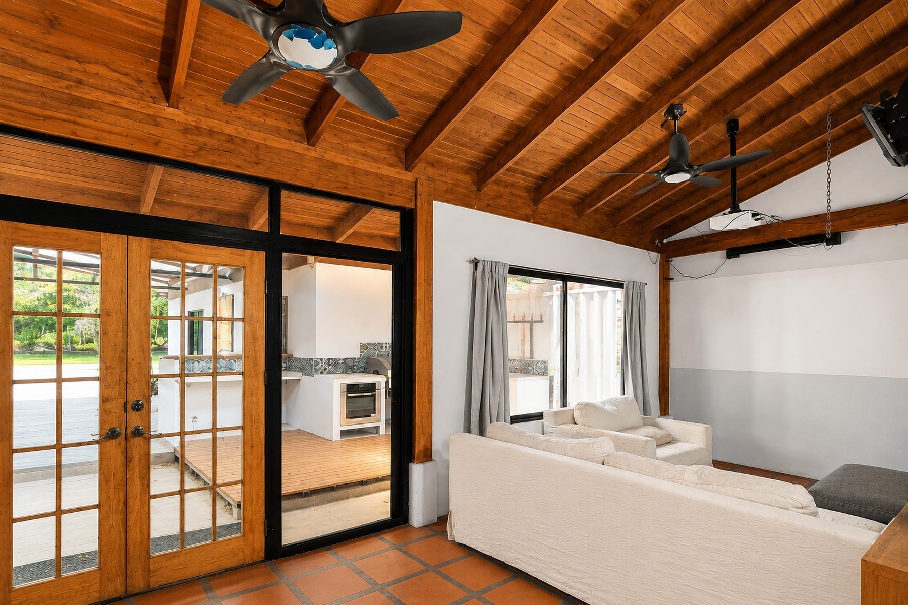 Sunroom with a wood ceiling and glass doors